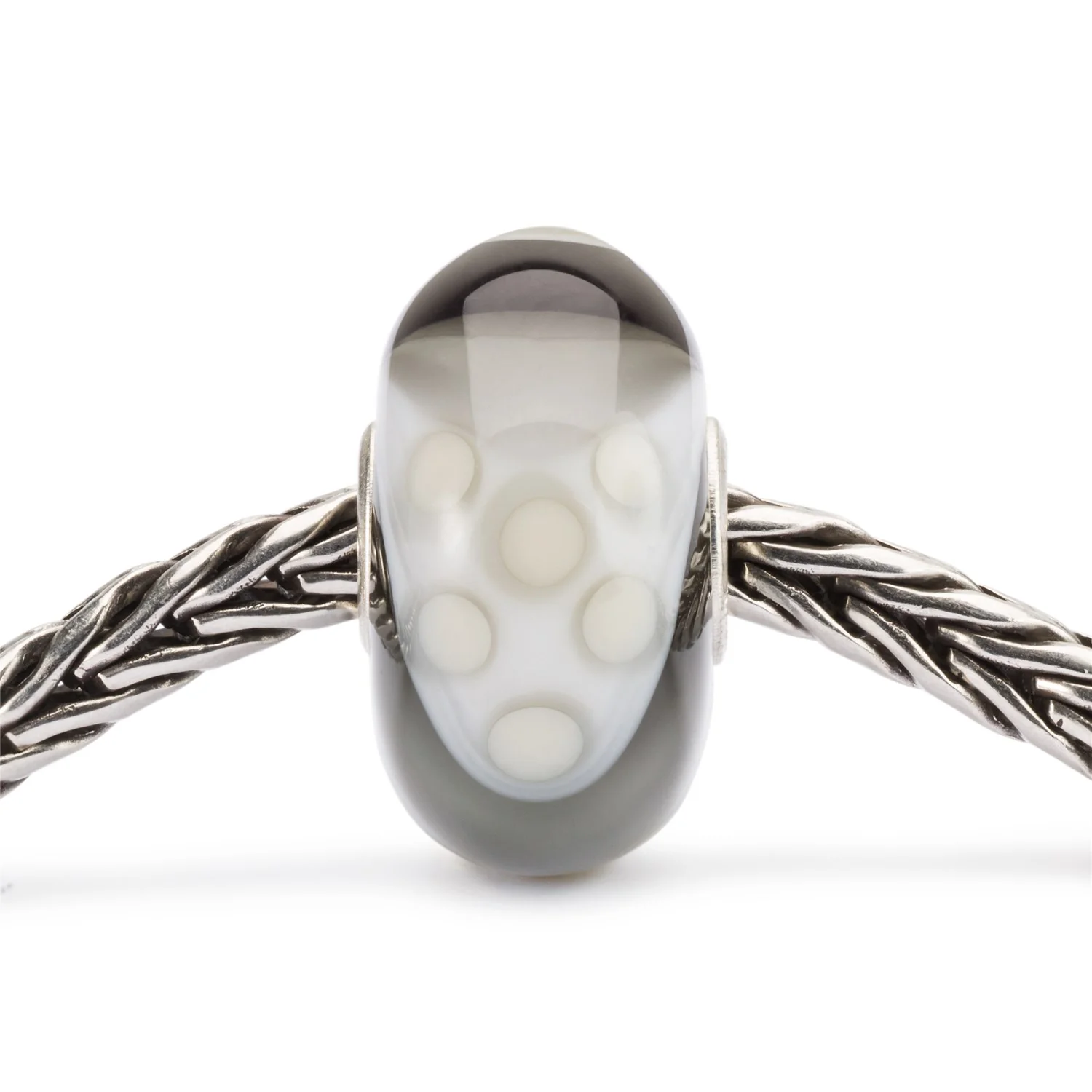 Bead Trollbeads Armadillo Fantasia in vetro con motivo a pois bianchi su fondo grigio sfumato.