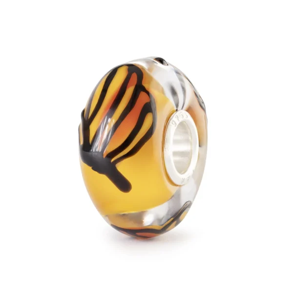 Bead Trollbeads Farfalla Del Sole in vetro con ali stilizzate arancioni e gialle su sfondo trasparente.